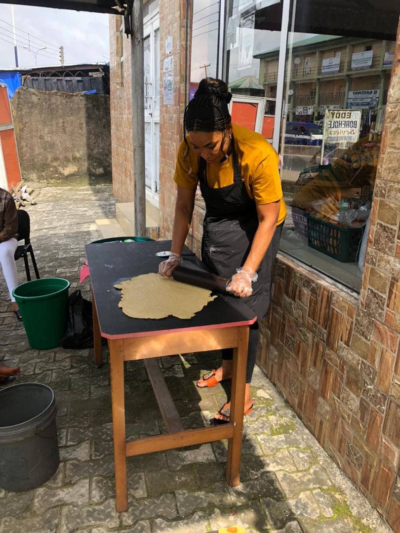 A participant rolling dough during a practical baking session