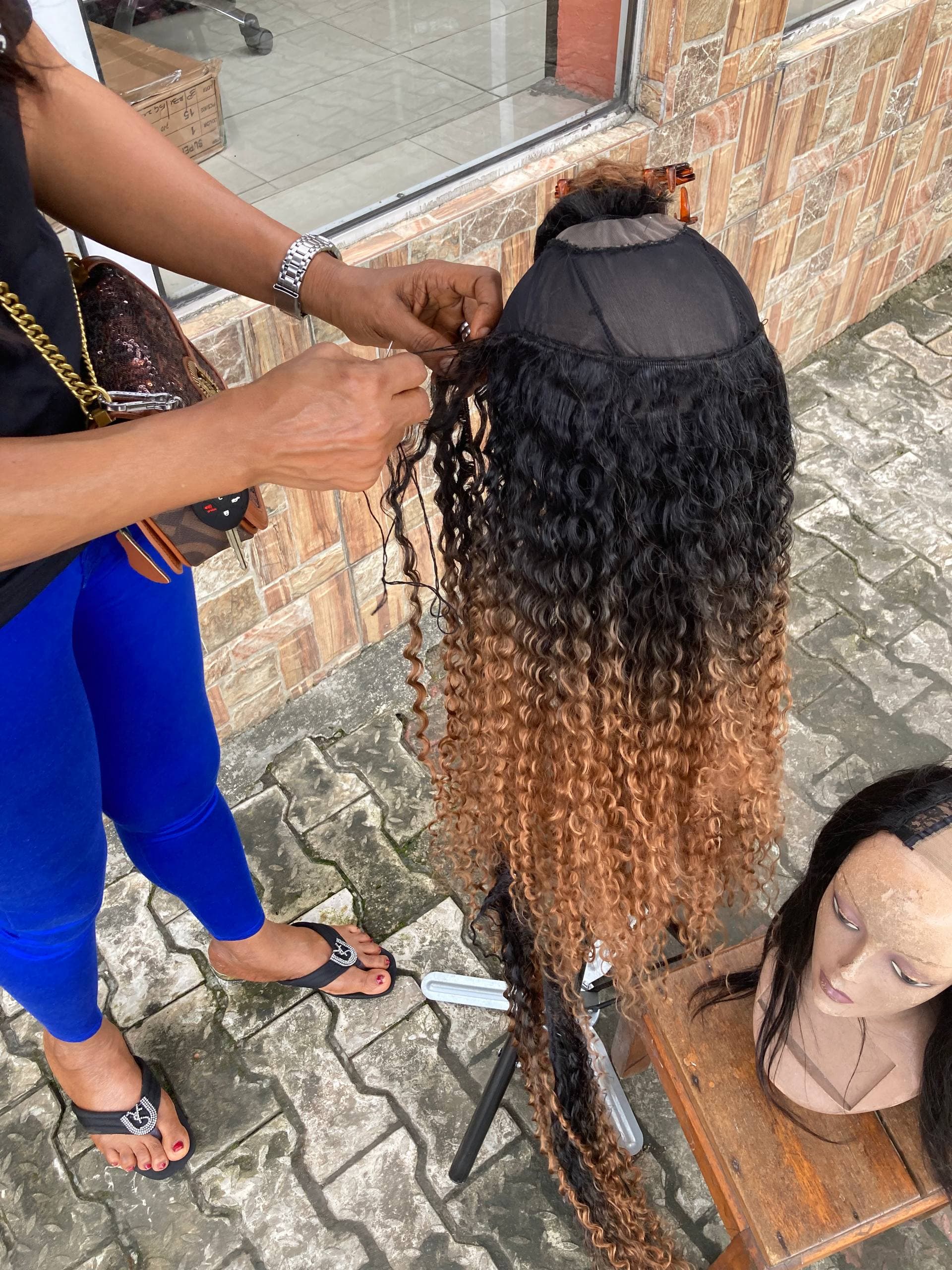 Close-up of a participant practising hair extension techniques